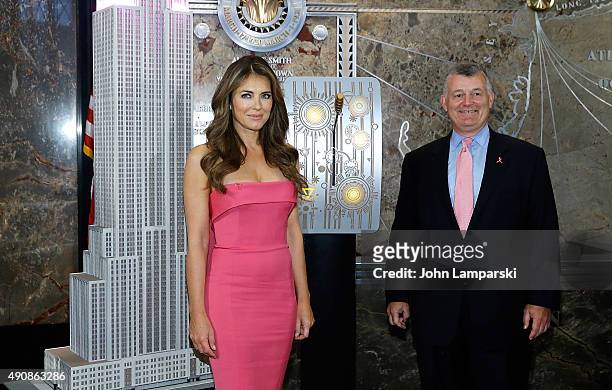 Elizabeth Hurley and William P. Lauder light the Empire State Building Pink at The Empire State Building on October 1, 2015 in New York City.