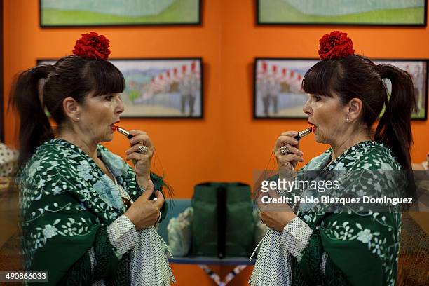 Chulapa' Pmakes up at the 'Association of Rompe y Rasga' premises during the San Isidro festivities before making her way to Pradera de San Isidro...