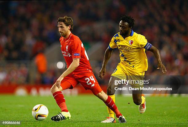 Joe Allen of Liverpool is marshalled by Laglais Kouassi of FC Sion during the UEFA Europa League group B match between Liverpool FC and FC Sion at...