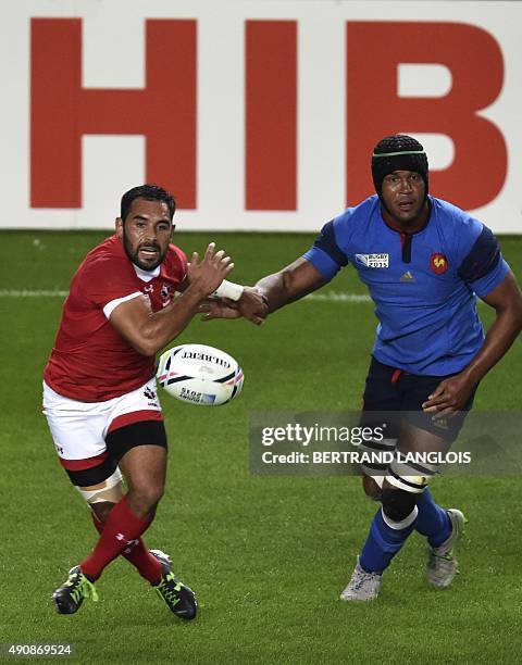 Canada's scrum half Phil Mack passes the ball next to France's flanker and captain Thierry Dusautoir during a Pool D match of the 2015 Rugby World...