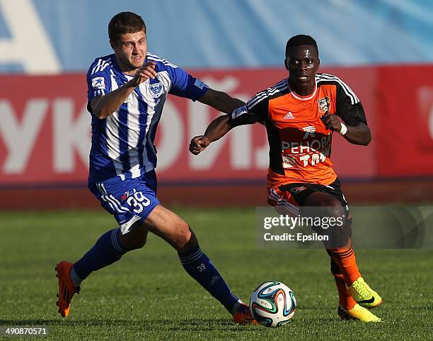 Artyom Danilenko of FC Volga Nizhny Novgorod challenged by Chisamba Lungu of FC Ural Sverdlovsk Oblast during the Russian Premier League match...