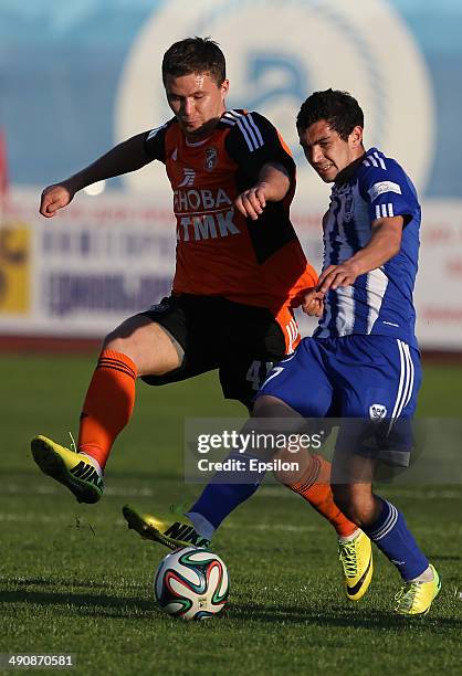 Artur Minosyan of FC Volga Nizhny Novgorod challenged by Aleksandr Sapeta of FC Ural Sverdlovsk Oblast during the Russian Premier League match...