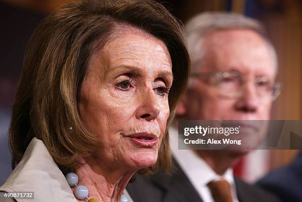 House Minority Leader Rep. Nancy Pelosi speaks as Senate Minority Leader Sen. Harry Reid listens during a news conference October 1, 2015 at the U.S....