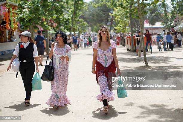 Women dressed as 'Chulapas' walk at Pradera de San Isidro park during the San Isidro festivities on May 15, 2014 in Madrid, Spain. During the...