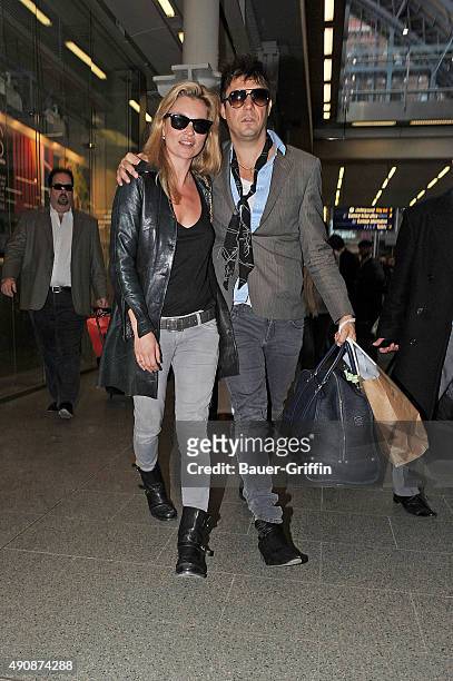 Kate Moss and Jamie Hince are seen at the KingâÃÃ´s Cross St Pancras Station on March 23, 2011 in London, United Kingdom.