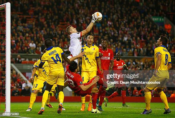 Andris Vanins of FC Sion makes a save as Emre Can of Liverpool goes to ground during the UEFA Europa League group B match between Liverpool FC and FC...