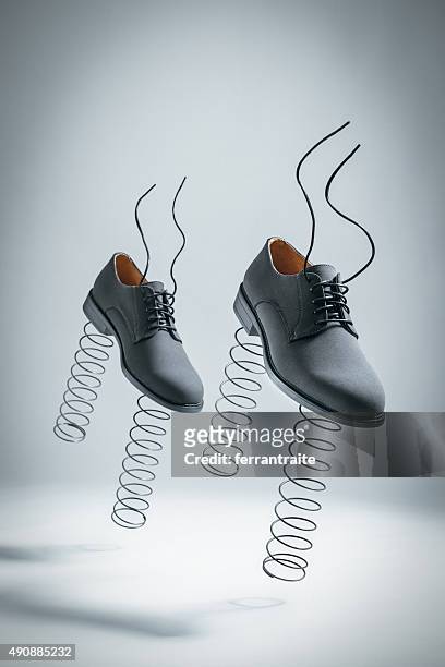 business shoes with springs jumping by themselves - footwear stock pictures, royalty-free photos & images
