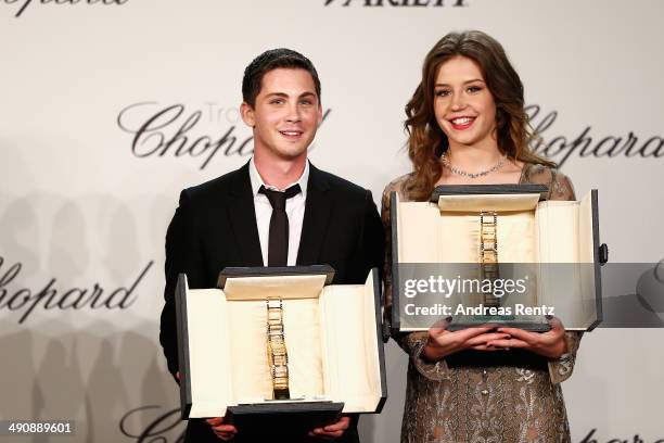 Actors Logan Lerman and Adele Exarchopoulos accept awards onstage at the Chopard Trophy during the 67th Annual Cannes Film Festival on May 15, 2014...