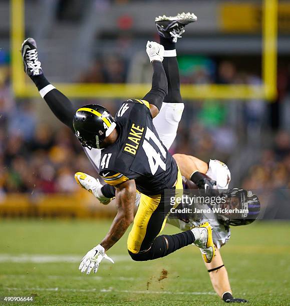 Antwon Blake of the Pittsburgh Steelers tackles Kyle Juszczyk of the Baltimore Ravens after making a catch during the game at Heinz Field on October...