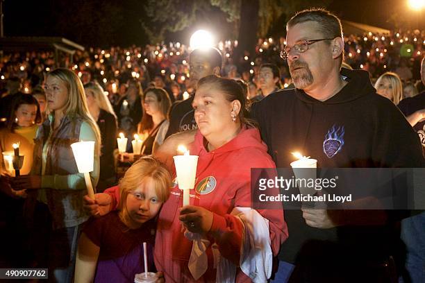 Denizens of Roseburg gather at a candlelight vigil for the victims of a shooting October 1, 2015 in Roseburg, Oregon. According to reports, 10 were...