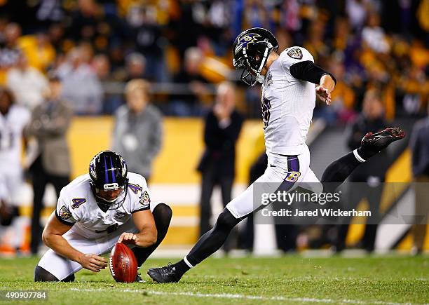 Sam Koch of the Baltimore Ravens holds the ball for kicker Justin Tucker as he attempts a 52-yard field goal in overtime. Tucker's kick led the...