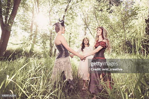 group of playful forest nymphs - woodland fairy costume stock pictures, royalty-free photos & images