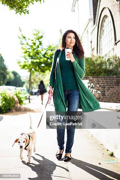 happy woman walking with dog in early sunday morning - happy lady walking dog stockfoto's en -beelden