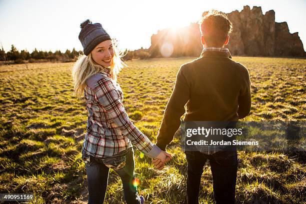 couple holing hands and smiling. - bend oregon fotografías e imágenes de stock