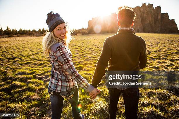 couple holing hands and smiling. - bend oregon stock pictures, royalty-free photos & images
