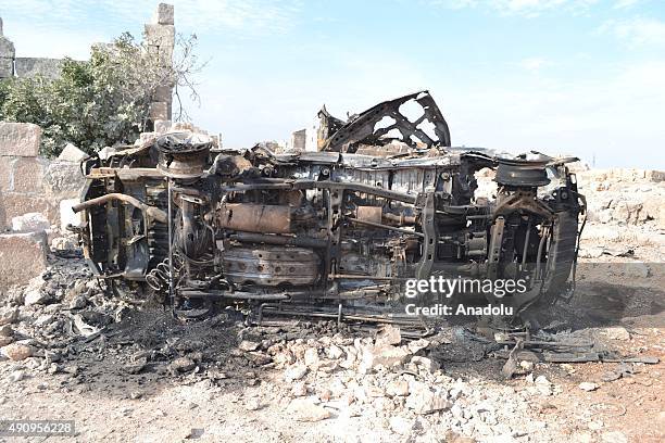 Damaged vehicle is seen at the site of the alleged Russian airstrikes targeting the training camp of Suqour al-Jabal Brigades in Kafr Nabl town of...