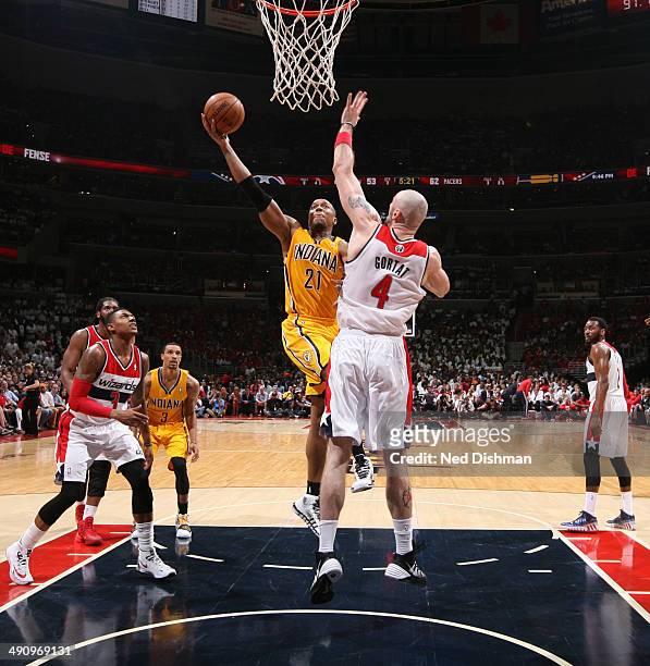 David West of the Indiana Pacers shoots against Marcin Gortat of the Washington Wizards in Game Six of the Eastern Conference Semifinals during the...