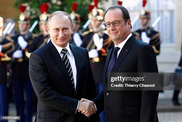 French President Francois Hollande welcomes Russian President, Vladimir Putin prior to their meeting at the Elysee Presidential Palace on October 02,...