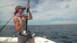Ms Woman Reeling Sport Fishing Tackle Rod On Boat On Ocean