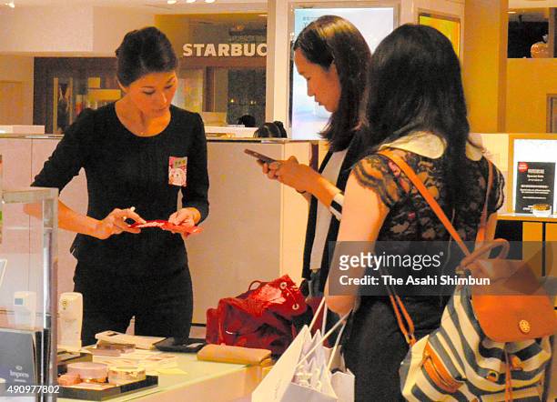Chinese tourists check products at Daimaru Department Umeda Branch on October 1, 2015 in Osaka, Japan. China is on holiday season with the National...