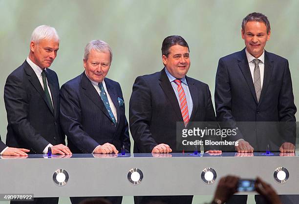 Left to right, Matthias Mueller, chief executive officer of Porsche AG, Wolfgang Porsche, chairman of Porsche AG, Sigmar Gabriel, Germany's economy...