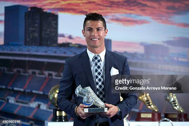 Cristiano Ronaldo poses for a picture with his trophy as all-time top scorer of of Real Madrid CF at Honour box-seat of Santiago Bernabeu Stadium on...