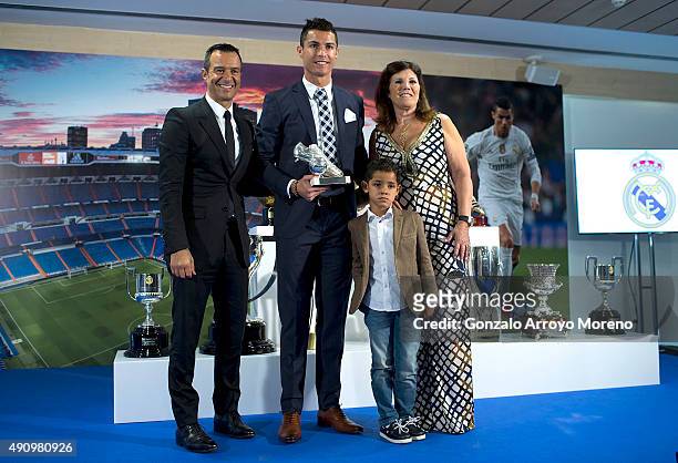 Cristiano Ronaldo poses for a picture with his trophy as all-time top scorer of of Real Madrid CF with his son Cristiano Ronald JR, mother Maria...