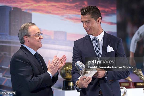 Cristiano Ronaldo receives the trophy as all-time top scorer of Real Madrid CF from president Florentino Perez at Honour box-seat of Santiago...