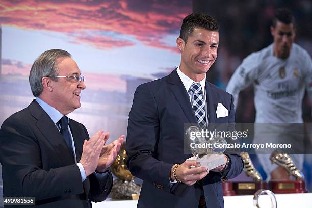 Cristiano Ronaldo poses with the trophy as all-time top scorer of Real Madrid CF and president Florentino Perez at Honour box-seat of Santiago...
