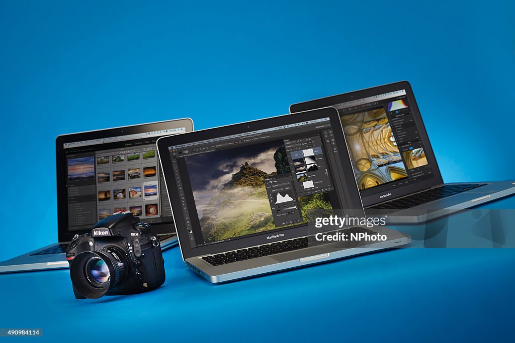 Ni Computer Photo A Nikon D800 DSLR camera alongside a trio of Apple MacBook Pro laptop ...