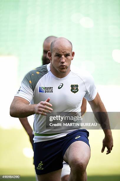 Australia's hooker and captain Stephen Moore runs during the captain's run training session on October 2, 2015 at Twickenham Stadium in southwest...