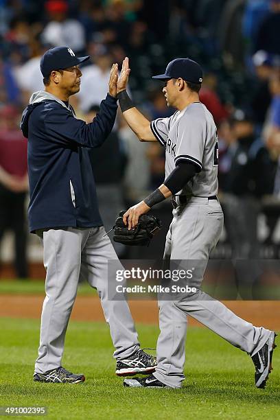 Hiroki Kuroda of the New York Yankees celebrates with Jacoby Ellsbury after defeating the New York Mets on May 15, 2014 at Citi Field in the Flushing...