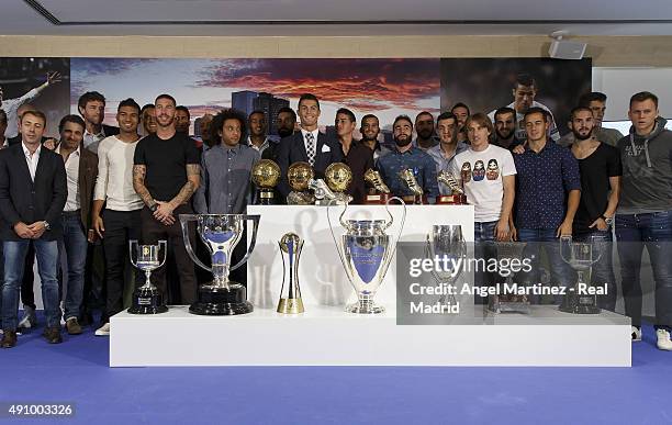 Cristiano Ronaldo poses for a picture with his trophy as all-time top scorer of Real Madrid CF lines up with all his teammates with all trophys at...