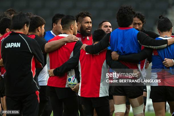 Japan's back row Ryu Koliniasi gathers his team-mates during the captain's run team training session in Milton Keynes, north of London, on October 2,...