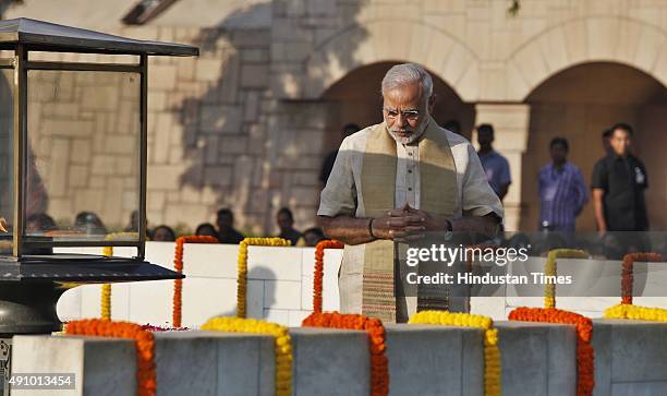 Prime Minister Narendra Modi pays tribute to Mahatma Gandhi on his 146th birth anniversary at Rajghat on October 2, 2015 in New Delhi, India....