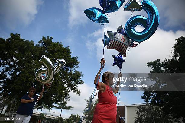 Wanda Francis and other campaign volunteers prepare to hang balloons as they prepare for the arrival of Democratic presidential candidate Hillary...