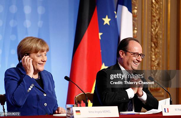 German Chancellor Angela Merkel and French President Francois Hollande hold a press conference following a summit on Ukraine on 02 October 2015, in...