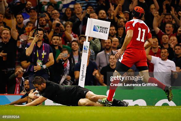 Dane Coles of the New Zealand All Blacks goes over to score their fourth try during the 2015 Rugby World Cup Pool C match between New Zealand and...