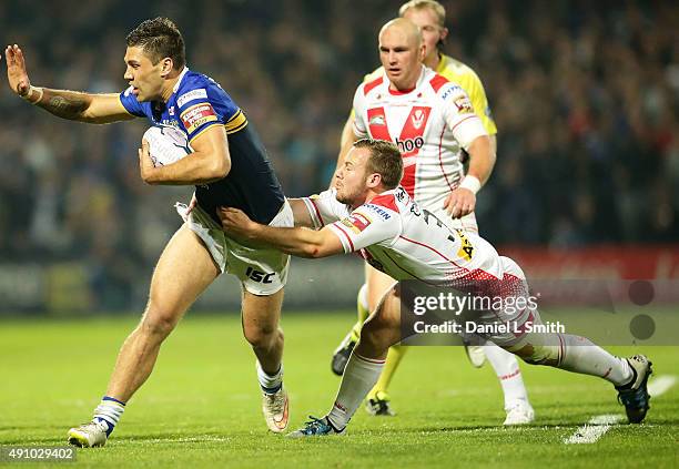 Adam Quinlan of St. Helens R.F.C pulls on Joel Moon of Leeds Rhinos during the First Utility Super League Semi Final between Leeds Rhinos and St...