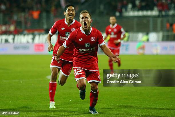 Pablo de Blasis of Mainz celebrates his team's third goal with team mate Yoshinori Muto during the Bundesliga match between SV Darmstadt 98 and 1.FSV...