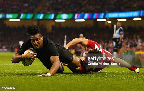 Julian Savea of the New Zealand All Blacks scores his team's sixth try and completes his hat trick as Giorgi Aptsiauri of Georgia challenges during...