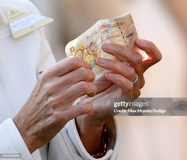 Sophie, Countess of Wessex holds a ten pound note as she attends the Autumn Racing & CAMRA Beer Festival meet at Ascot Racecourse on October 2, 2015...