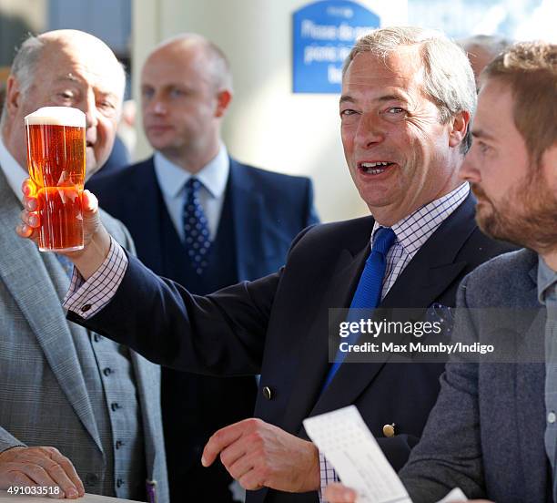 Nigel Farage drinks a beer as he attends the Autumn Racing & CAMRA Beer Festival meet at Ascot Racecourse on October 2, 2015 in Ascot, England.