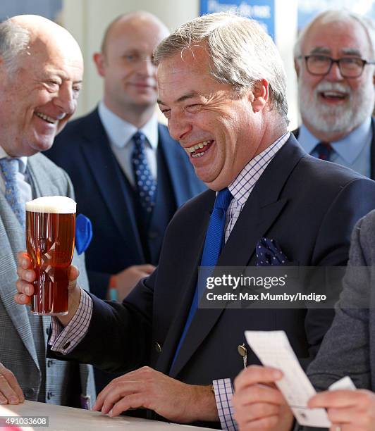 Nigel Farage drinks a beer as he attends the Autumn Racing & CAMRA Beer Festival meet at Ascot Racecourse on October 2, 2015 in Ascot, England.