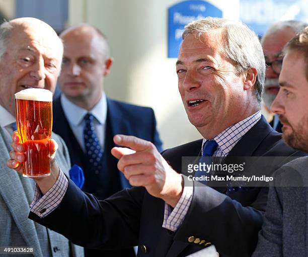Nigel Farage drinks a beer as he attends the Autumn Racing & CAMRA Beer Festival meet at Ascot Racecourse on October 2, 2015 in Ascot, England.