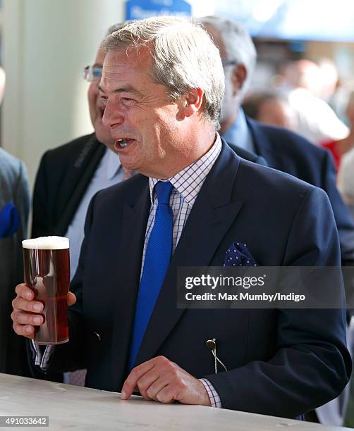 Nigel Farage drinks a beer as he attends the Autumn Racing & CAMRA Beer Festival meet at Ascot Racecourse on October 2, 2015 in Ascot, England.