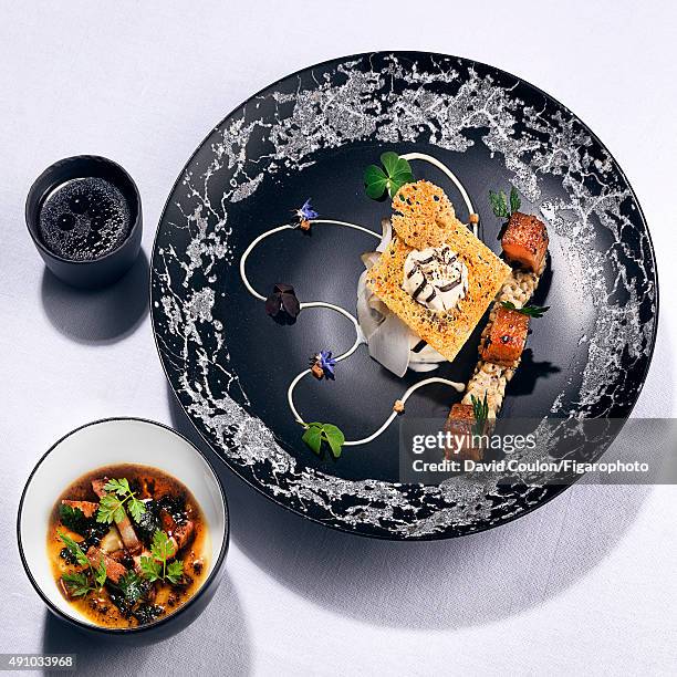 Chef Sylvestre Wahid's recipe of hen's egg and celery with lukewarm smoked black truffle, is photographed for Madame Figaro on June 26, 2015 in...