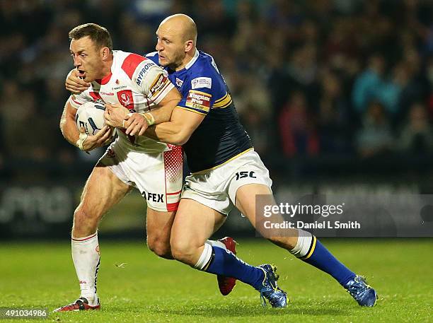 Carl Ablett of Leeds Rhinos tackles James Roby of St. Helens R.F.C during the First Utility Super League Semi Final between Leeds Rhinos and St...