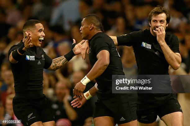 Waisake Naholo of the All Blacks is congratulated on his try by Aaron Smith and Conrad Smith during the 2015 Rugby World Cup Pool C match between New...