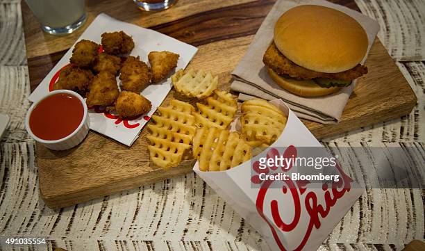 Chicken nuggets, french fries, and a fried chicken sandwich are arranged for a photograph during an event ahead of the grand opening for a...